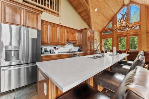 The kitchen features high-end stainless appliances including a gas stove.