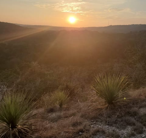 The Hill Country cliffs come alive at sunset, offering breathtaking views and a serene backdrop for the property.