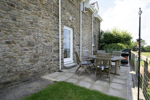 Patio table and six chairs. Gas BBQ. View over fields