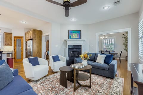 Bright and airy lounge area with stylish décor and ceiling fan.