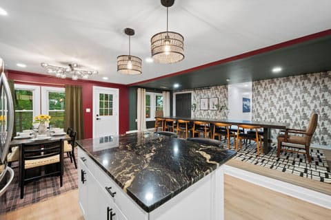 Our fully stocked kitchen, complete with modern lighting, offers the perfect space for creating culinary delights.