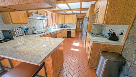 The spacious brick floored Kitchen has updated counters, Microwave, Double Oven and Fridge/Freezer