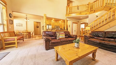 The Living Area with vaulted ceiling, Dining and Kitchen.