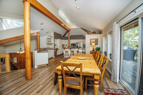 The Dining table sits in the center with sliding glass door leading out to the deck for summer dining