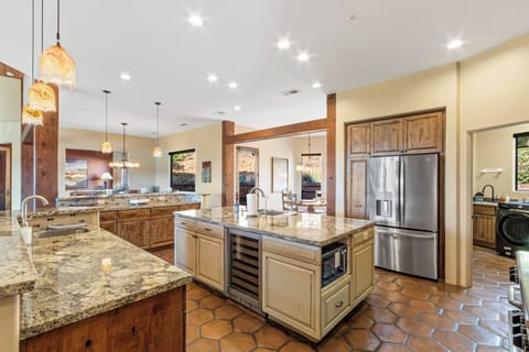 Chef's kitchen with a wine fridge and water/ice on the refrigerator door