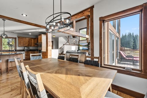 Dining area: Table seating for 8, 3 barstools at kitchen counter