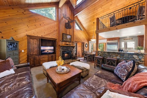 Vaulted great room with stone fireplace, oversized seating, and space for your whole group to gather