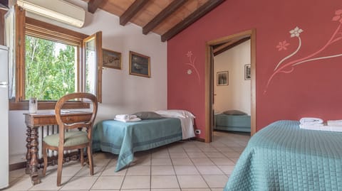 bright room with 2 single beds and 1 doublebed