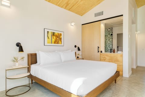 Unit A4 features a king bed, ensuite bathroom, private patio, and TV.