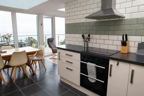 Kitchen with metro tiled walls leading into the dining area