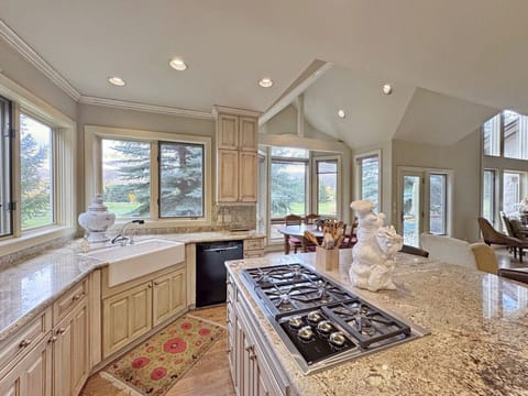 This elegant kitchen with a Wolf stovetop is plenty big to serve the 14 guests that this home is equipped to host