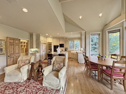 A look into the hearth room, nook, and kitchen from the 2-way gas fireplace that splits the living area