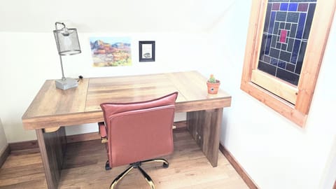 Work from home space, with large desk and comfy rolling leather rolling chair