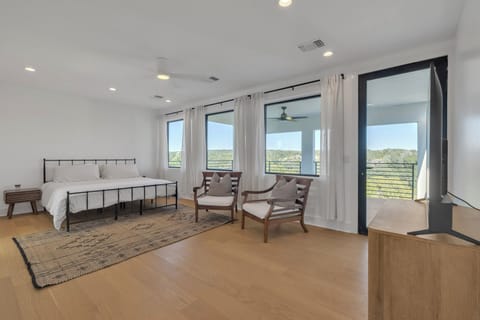 King bedroom with private balcony overlooking river. 