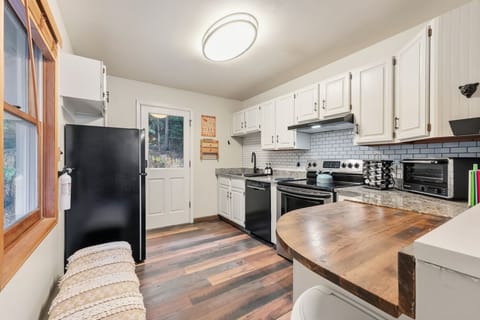 Kitchen: Main floor, drip coffee maker, blender, toaster, cooking utensils, tableware