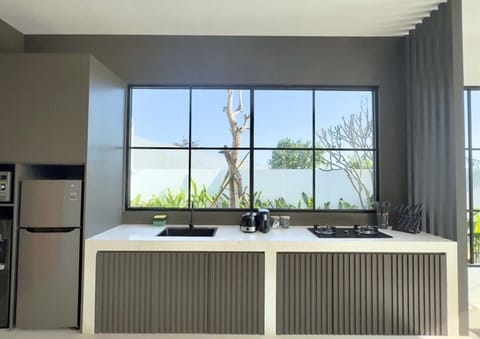 Warm and welcoming, this fully equipped kitchen features quality finishes and thoughtful design, ideal for family meals and gatherings. #Villa Patuha