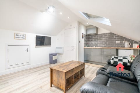 Open-plan attic studio with sofa and stylish touches