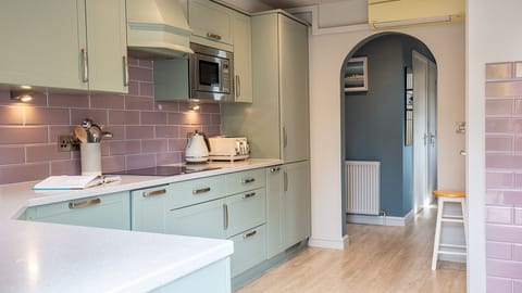 Hidden in a pantry cupboard are the laundry facilities which include a washing machine and tumble dryer.