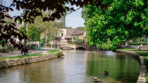 Visitors flock to Bourton-on-the-Water to spend time amongst this picture-postcard setting.