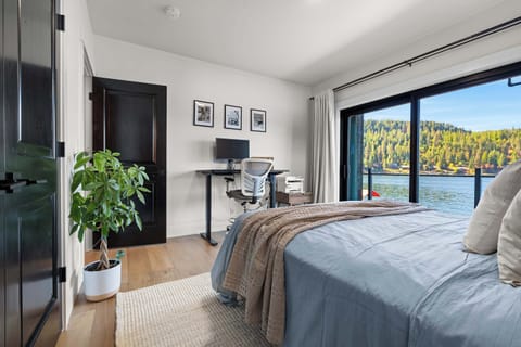 Wake up to panoramic lake views and soft morning light. Whether you’re writing, working, or simply dreaming, this peaceful bedroom blends serenity and inspiration with its private deck and dedicated workspace overlooking the water.