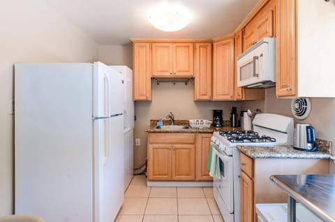 Functional kitchen with stove, refrigerator, and basic cooking tools for your stay.