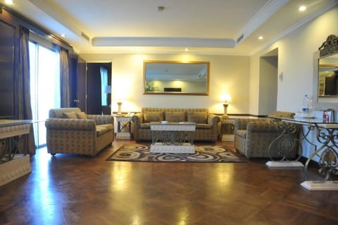 Deluxe Suite, 1 King Bed, 2 Bathrooms | Living area | 52-inch flat-screen TV with cable channels, TV, books