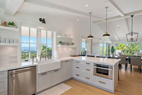 The kitchen features barstool seating, ample counter space and reliable appliances. (Main house)