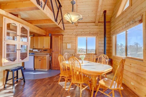Dining Room: Gather around the bright dining table with stunning mountain views and warm wooden charm!

