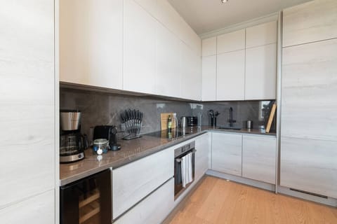 Bright, modern kitchen fully equipped for cooking — perfect for everything from your morning coffee to an evening meal after a day in the city.