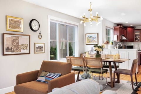 Dining area with modern chandelier overlooking the kitchen.