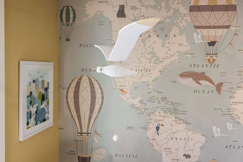 Whimsical seagull mobile adds charm to the travel-themed kids’ room.