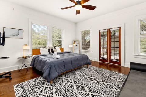 Upstairs King Suite. Spacious and serene, this sunlit suite features a plush King bed and cozy lounge seating.