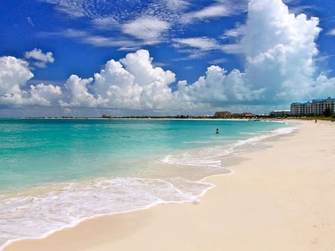 On the beach, white sand, beach umbrellas, beach towels