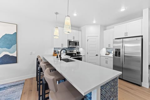 Full kitchen with stainless steel appliances and breakfast bar seating