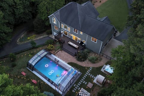 Backyard retreat featuring a hot tub, barrel sauna, and life-size chess set.