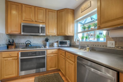 Modern appliances and bright kitchen window views.