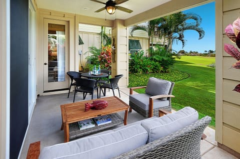 Relaxing lanai with seating amid tropical greenery — your quiet spot to unwind or enjoy evening breeze.