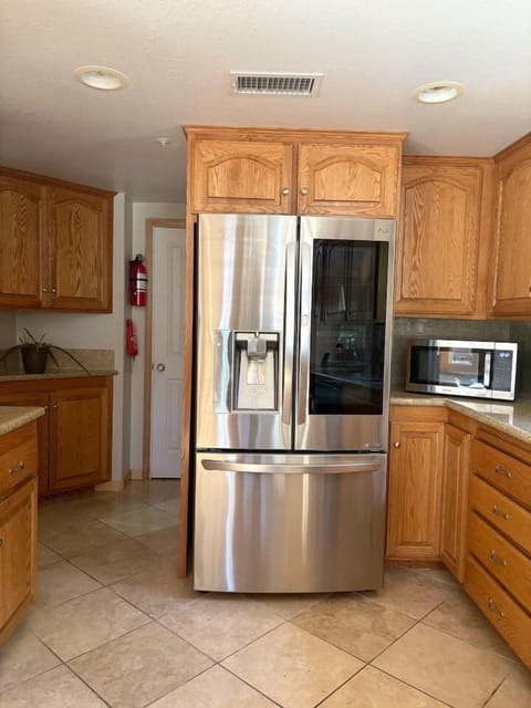 Modern, full-sized refrigerator with ice and water dispenser.
