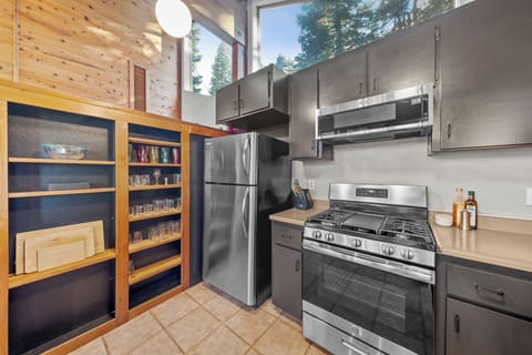 Fully equipped kitchen with stainless steel appliances and wood cabinetry.