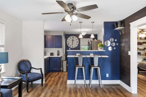 Kitchen: Cook and Connect – Enjoy this inviting kitchen with bold blue cabinetry, sleek finishes, and cozy seating that makes mealtime a delight.