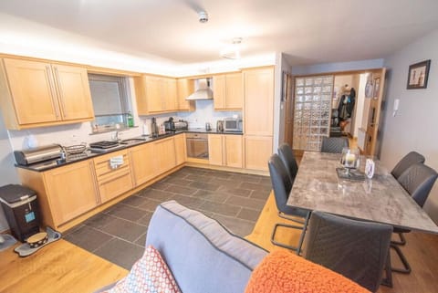 Open-plan layout of kitchen, dining, and lounge