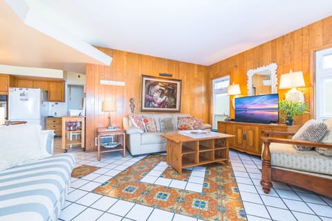 Adjacent to the kitchen, the media room provides an inviting open-concept space for lounging