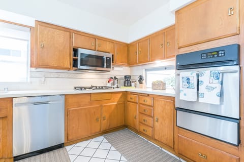 The kitchen is fully stocked with dishes, utensils, cookware, bakeware, small appliances, and all major appliances