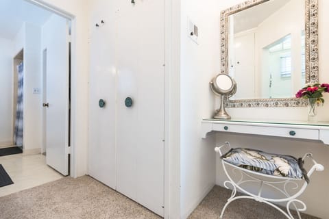 The dual-access bathroom is accessible from the primary suite and hallway, with a privacy door available to separate the two sides