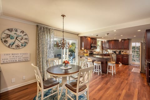 From this angle, the breakfast area opens to the backyard through the sliding doors, giving you a clear view of the outdoor dining space and fire pit — an easy blend of indoor comfort and outdoor living.