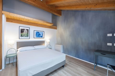 Deluxe Triple Room, Private Bathroom | In-room safe, desk, laptop workspace, blackout drapes