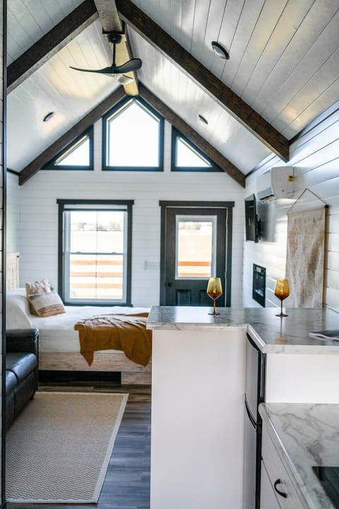 Bedroom - Queen bed with luxury linens, electric fireplace, and TV for cozy, restful evenings