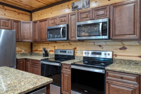Multiple stoves, microwaves, and refrigerators in the kitchen for your group.