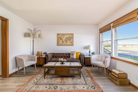 The living room is the perfect display of a Vintage Travel Suite! Featuring an oversized love seat couch and 2 chairs you're guaranteed to have a spot to kick back after all your travelling adventures.