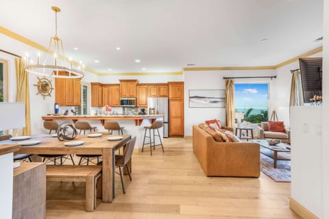 Warm and inviting living room, dining area and kitchen with ocean views